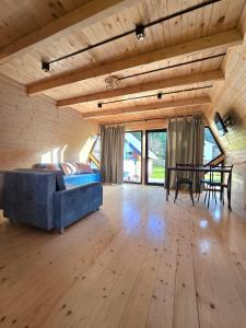 a living room with a blue couch and a table at Borjomi Hills in Borjomi