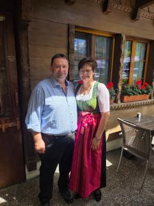a man and a woman standing in front of a building at Hotel Altels in Kandergrund