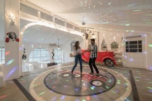 a man and a woman playing a game on a bowling alley at StayVista's Casa Blanca - Modern elegance with a pool, spacious lawn & diverse activities in Karjat