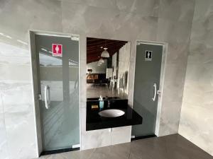 a bathroom with a sink in the middle of a room at Sonho Meu in Saquarema +22 photos