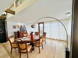 a dining room with a table and chairs at Spacious Apartment in City Centre in Iaşi