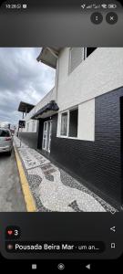 a picture of a building with a street at Pousada Beira Mar in Matinhos