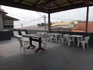 a table and chairs sitting on a patio at Pousada Beira Mar in Matinhos