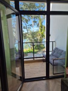 a sliding glass door with a view of a balcony at Gonik NN Apartmani in Veliko Gradište