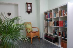 a room with a book shelf filled with books at Ferienhaus Binz in Binz
