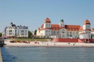 a group of people on the beach in front of a large building at Ferienhaus Binz in Binz +106 photos