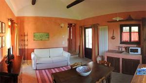 a living room with a white couch and a table at Agriturismo Preggio in Umbertide
