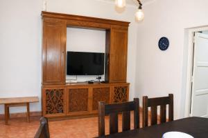 a living room with a television in a wooden entertainment center at Arístides Azul in Mendoza