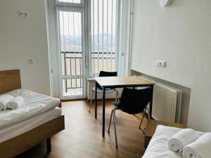a room with a desk and a table and a bed at Sanatorium Rosomak in Ustroń +21 photos
