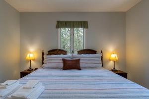 a bedroom with a large bed with two lamps at Home Away From Home · Home-Away-From-Home in Rosman +22 photos