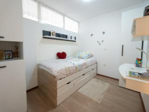 a small bedroom with a bed and a desk at LUNA APARTMENTS Quiet Retreat, Close to Koper, AirCon, Parking in Ankaran +36 photos