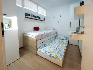 a small bedroom with a bed and a sink at LUNA APARTMENTS Quiet Retreat, Close to Koper, AirCon, Parking in Ankaran