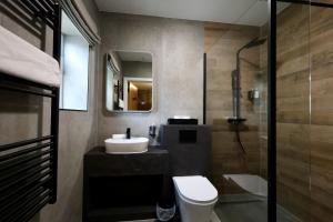 a bathroom with a sink and a toilet and a shower at Y Seren Hotel & Restaurant in Carmarthen +22 photos