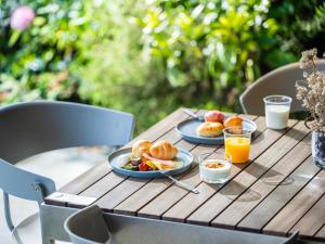 a table with two plates of food and orange juice at LACER SUITES KAMAKURA -formerly kamakura seizan- in Kamakura +28 photos