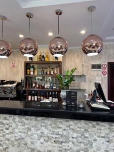 a bar at a restaurant with pendant lights at Hotel Terra Iasi in Iaşi