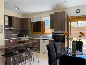a kitchen with a table with chairs and a counter top at Alkinoou Residence in Limassol