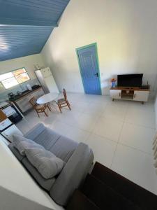 a living room with a couch and a tv in it at Recanto dos Valles in Búzios