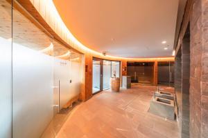 an open hallway with a stone wall and a staircase at The Alpina Mountain Resort in Tschiertschen