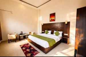 a bedroom with a bed and a desk and a chair at Foxoso Heights, Tapovan in Rishīkesh +38 photos