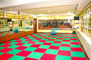a room with a checkered floor in a library at Greenvale Hotel 1BR Along Kamiti Road in Kiambu