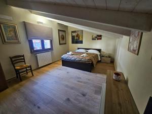 a bedroom with a bed and a wooden floor at LA CASA Di Nonno Angelo in Capo di Ponte +57 photos