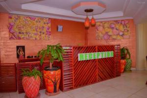 a store with a sign in a room with plants at Greenvale Hotel 1BR Along Kamiti Road in Kiambu