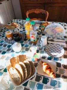 a table with a table cloth with food on it at Le Logis du GAST Chambre Taupe in Le Gast