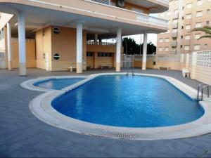 a large swimming pool in front of a building at Sea View Apartman Daimus in Daimuz