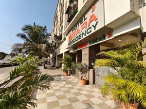 a building with a sign on the side of it at Hotel Sitara Residency in Navi Mumbai