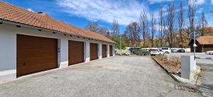 a row of garages in a parking lot at Mill Apartments in Český Krumlov