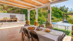 an outdoor dining room with a table and chairs at Casa Corazón 44 Torrox by Ruralidays in Torrox