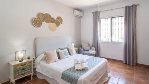 a bedroom with a bed with two shoes on it at Casa Corazón 44 Torrox by Ruralidays in Torrox +32 photos