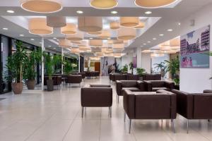 a lobby with couches and chairs in a building at Alimounda Mare Hotel in Karpathos +97 photos