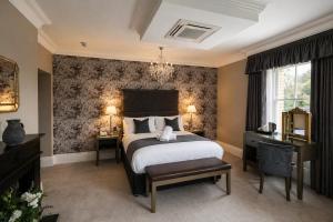 a bedroom with a large bed and a window at Y Seren Hotel & Restaurant in Carmarthen