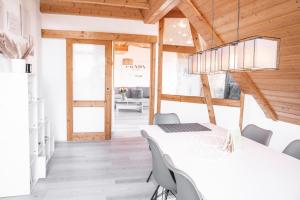 a dining room with a white table and chairs at Wohnung am Bodensee in Moos