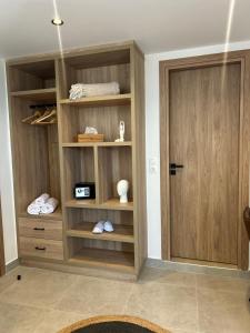 a closet with wooden shelves and a door at Starlight Ocean View in Kardamaina +62 photos