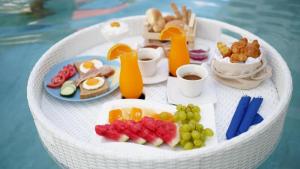 a white table with breakfast foods and drinks on it at Zante Park Resort & Spa BW Premier Collection in Laganas