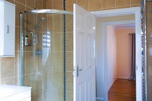 a shower with a glass door in a bathroom at CosyColeby in Nottingham +13 photos