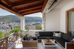 a living room with a couch and a balcony at Villa Peragro in Dubrovnik
