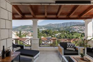 a balcony with a view of the mountains at Villa Peragro in Dubrovnik