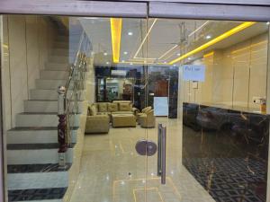a glass door in a building with a living room at Royal Guest House in Jammu