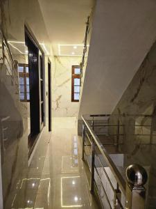 a staircase in a building with a marble wall at Royal Guest House in Jammu