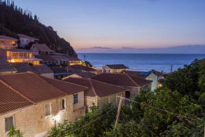 a town with houses and the ocean at dusk at Olive Tree-Member of My Villas Hospitality in Lefkada +18 photos