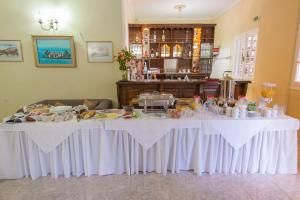 a white table with food on it in a room at Olive Tree-Member of My Villas Hospitality in Lefkada