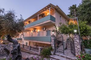 a large white house with a balcony at Olive Tree-Member of My Villas Hospitality in Lefkada