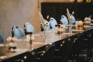a set of tables with chairs and flowers on them at Van der Valk Hotel Gent-Drongen in Ghent +44 photos