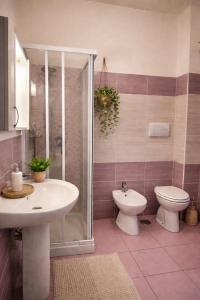 a bathroom with a toilet and a sink and a shower at B&B MULA Germaneto in Santa Maria