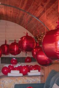 a group of red lanterns hanging from a ceiling at Meadow View in Rhayader