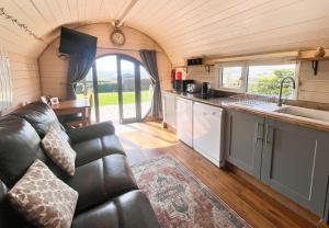 a kitchen and living room in a tiny house at Mountain View Pod in Rhayader