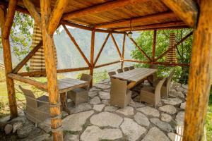 a wooden table and chairs in a gazebo at Wings of Tatev Private Villa in Halidzor